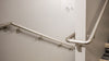 silver handrail curving around wall along staircases